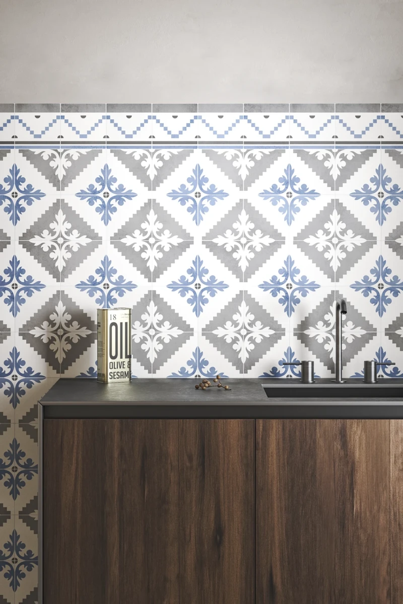 Küchenwand gestaltet mit handwerklich gefertigten Fliesen auf weißer Basis und Design in Grau und Blau